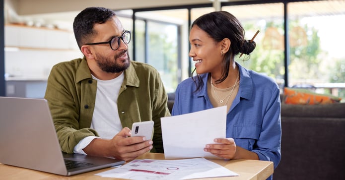 Homeowners reviewing the monthly cost of owning a single-family home