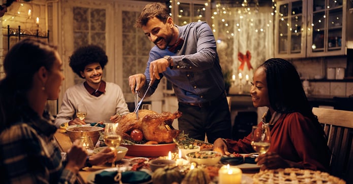 Millennial and Gen Z friends sharing a holiday meal at home, highlighting the next wave of homeownership.