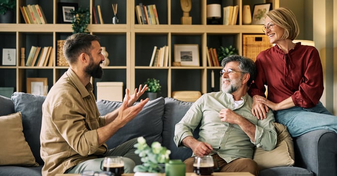 Young adult at home talking to parents